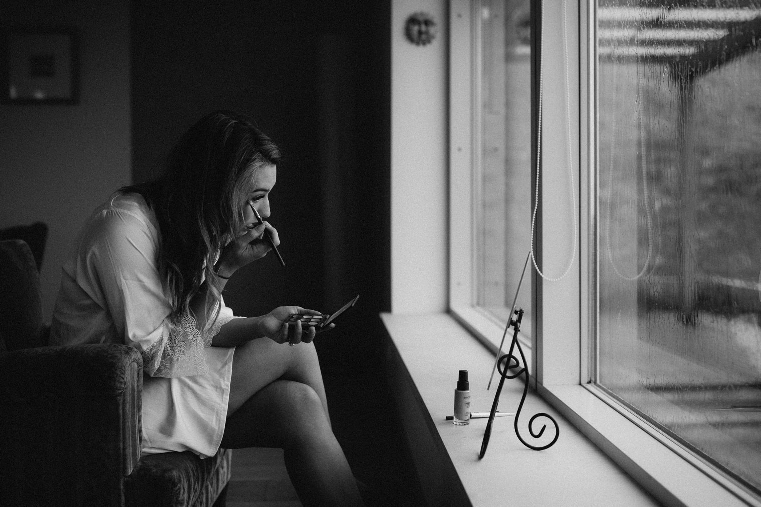 Bride doing her own makeup for her iceland destination wedding 